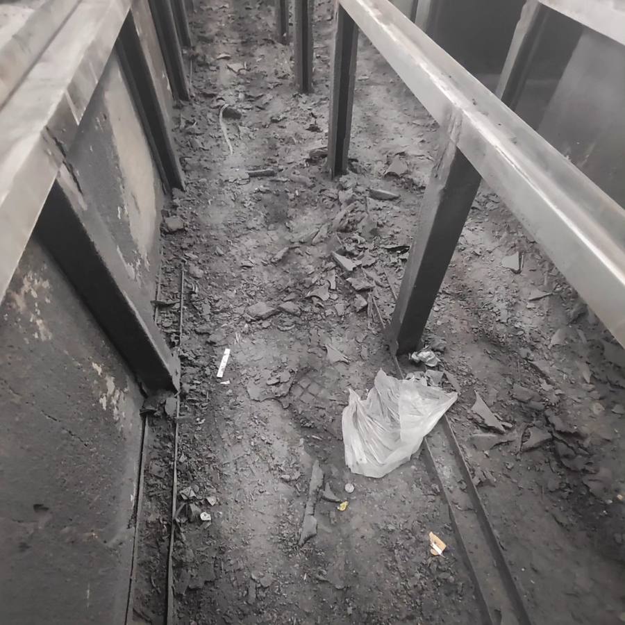 A downdraft pit full of overspray debris before cleaning